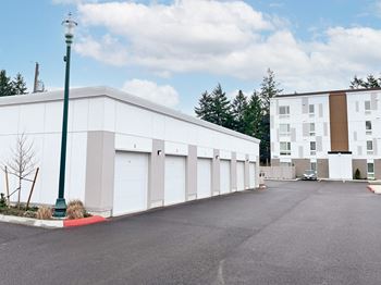 A large white building with a parking lot in front of it
